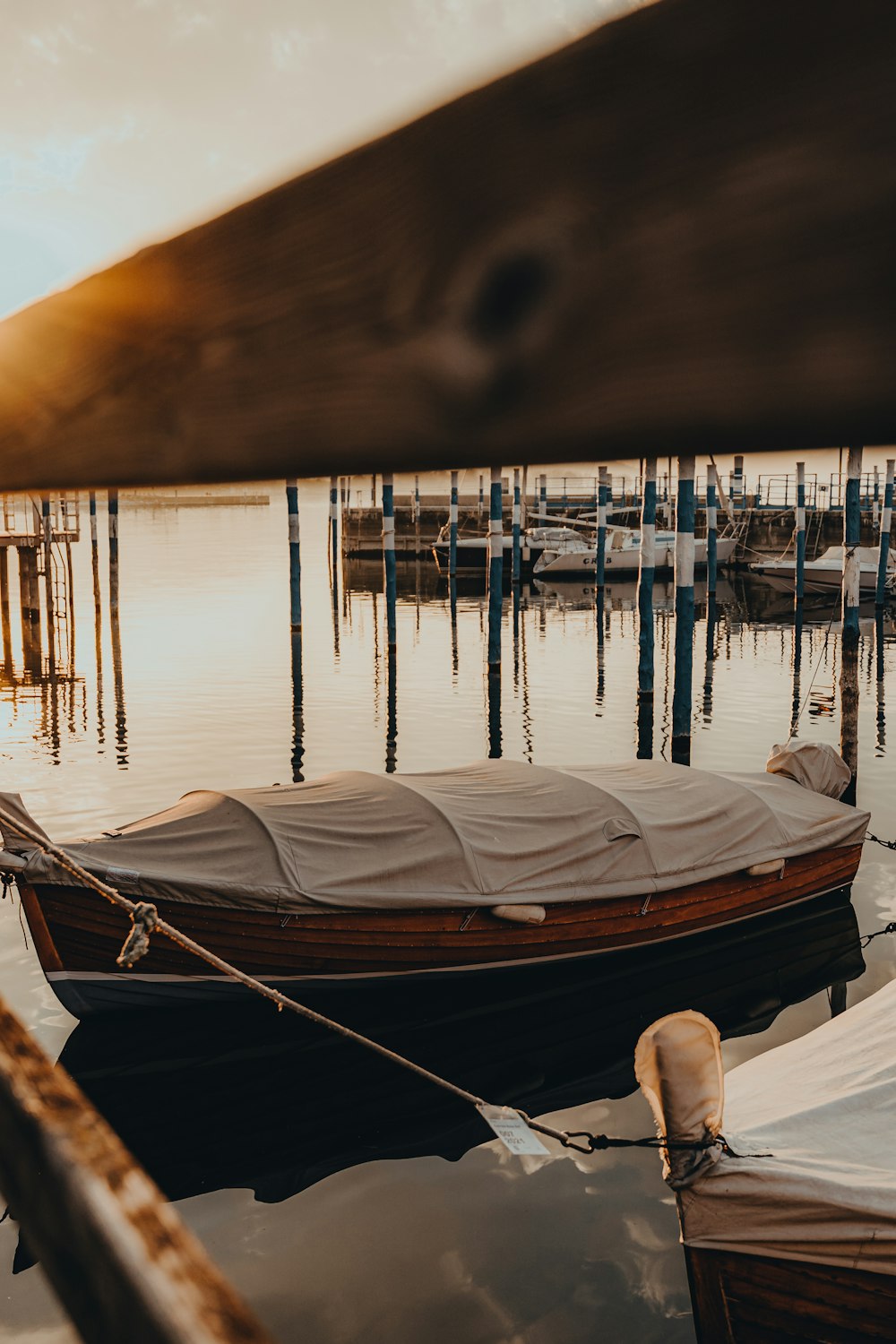 a row boat tied to a dock in the water