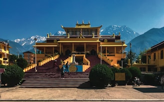 a large yellow building with steps leading up to it