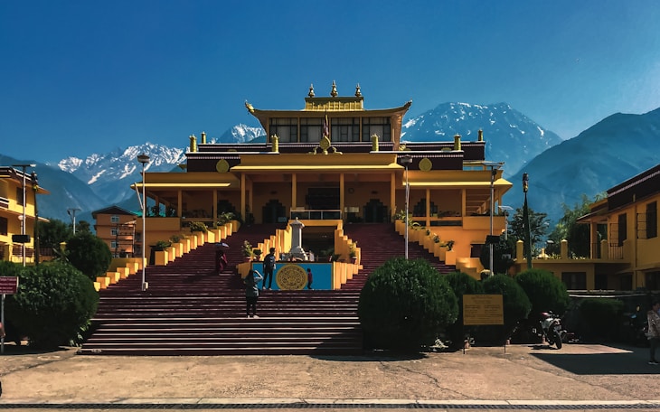 a large yellow building with steps leading up to it