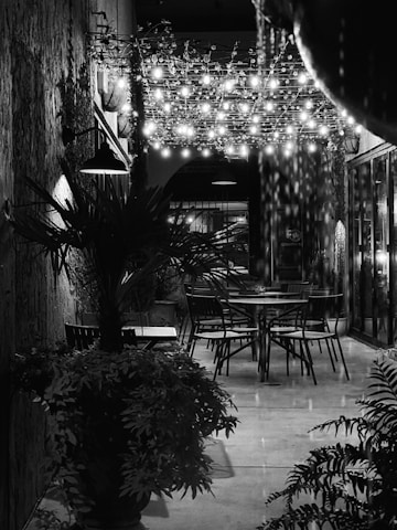 A cozy outdoor seating area at Cortijo El Maizal decorated with fairy lights for an evening celebration.