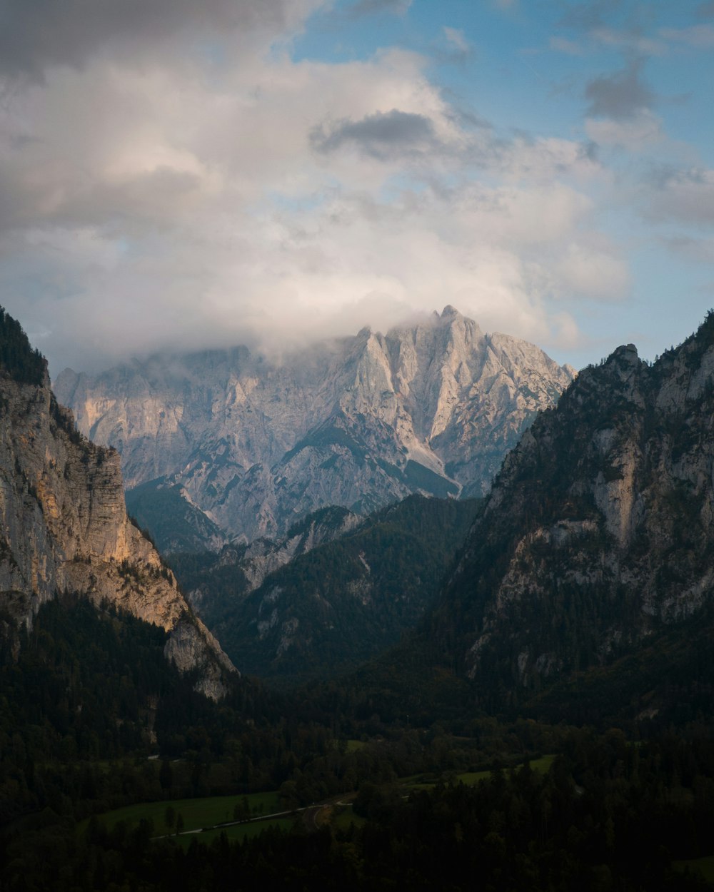 a view of a mountain range with clouds in the sky