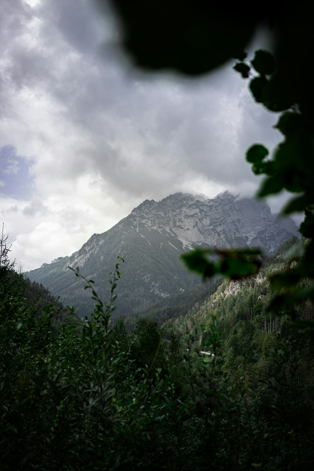 a view of a mountain with a cloudy sky