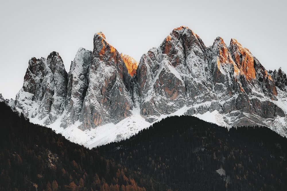 a mountain range covered in snow in the winter