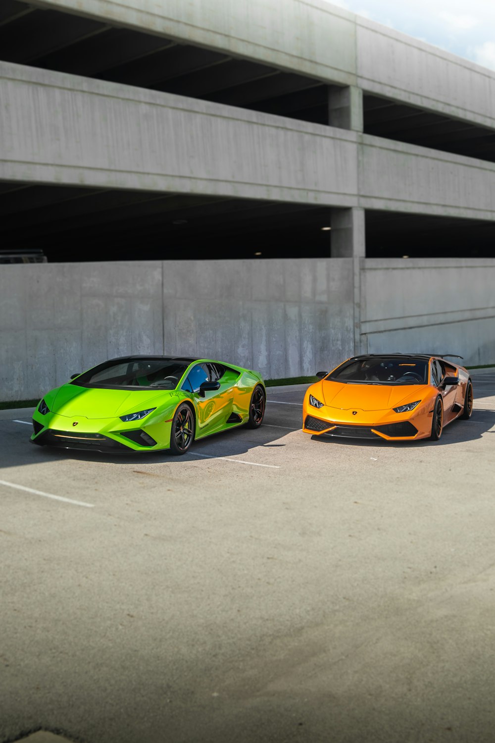 a couple of cars parked next to each other in a parking lot