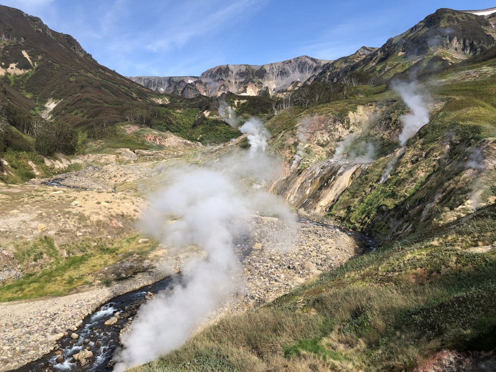 steam rises from a river in a valley