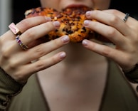 A close-up of hands exchanging gluten-free bread at a Chesed Gluten Free food distribution.