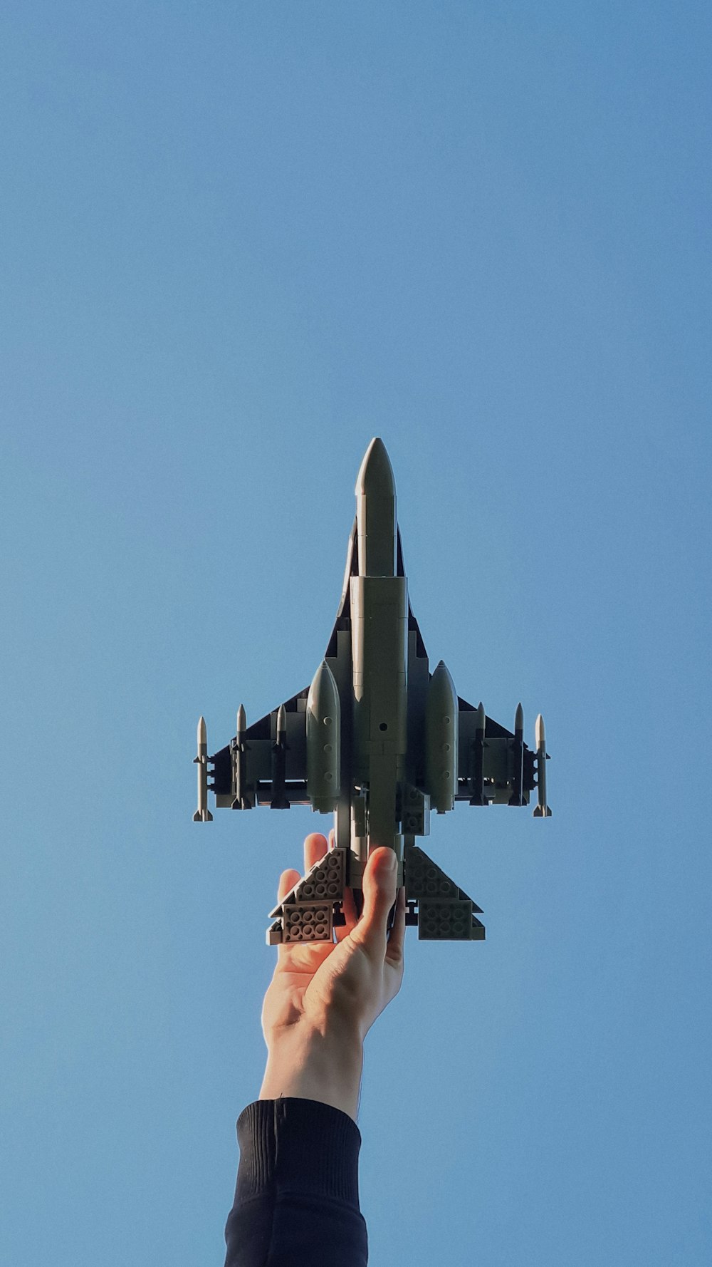 a person holding a model airplane in their hand