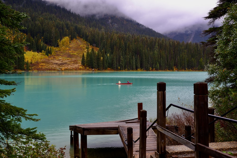 a boat on a lake surrounded by trees