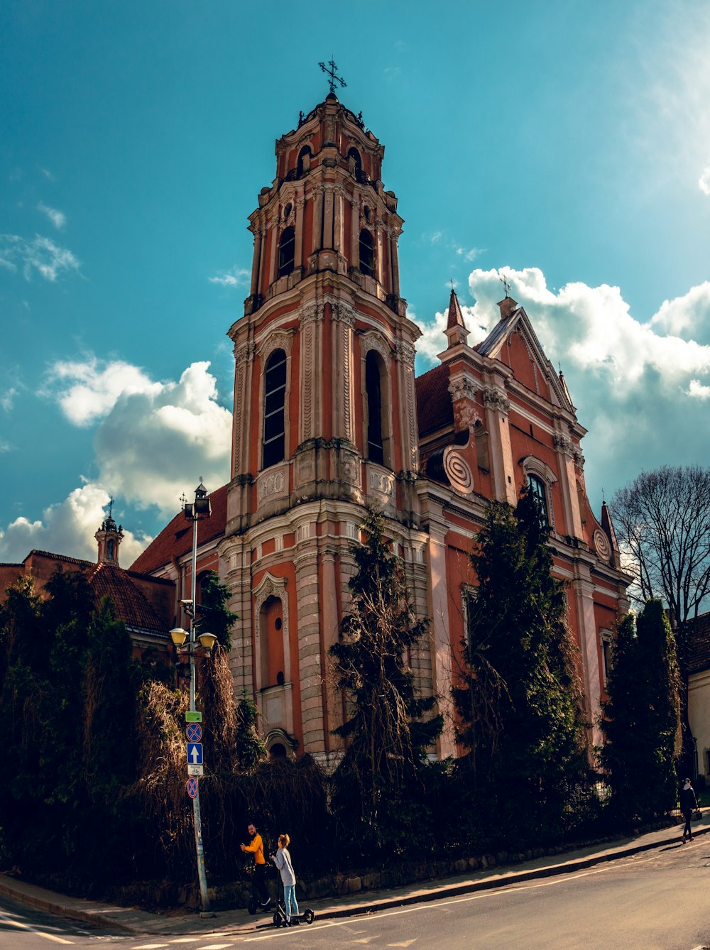 two people standing in front of an old church