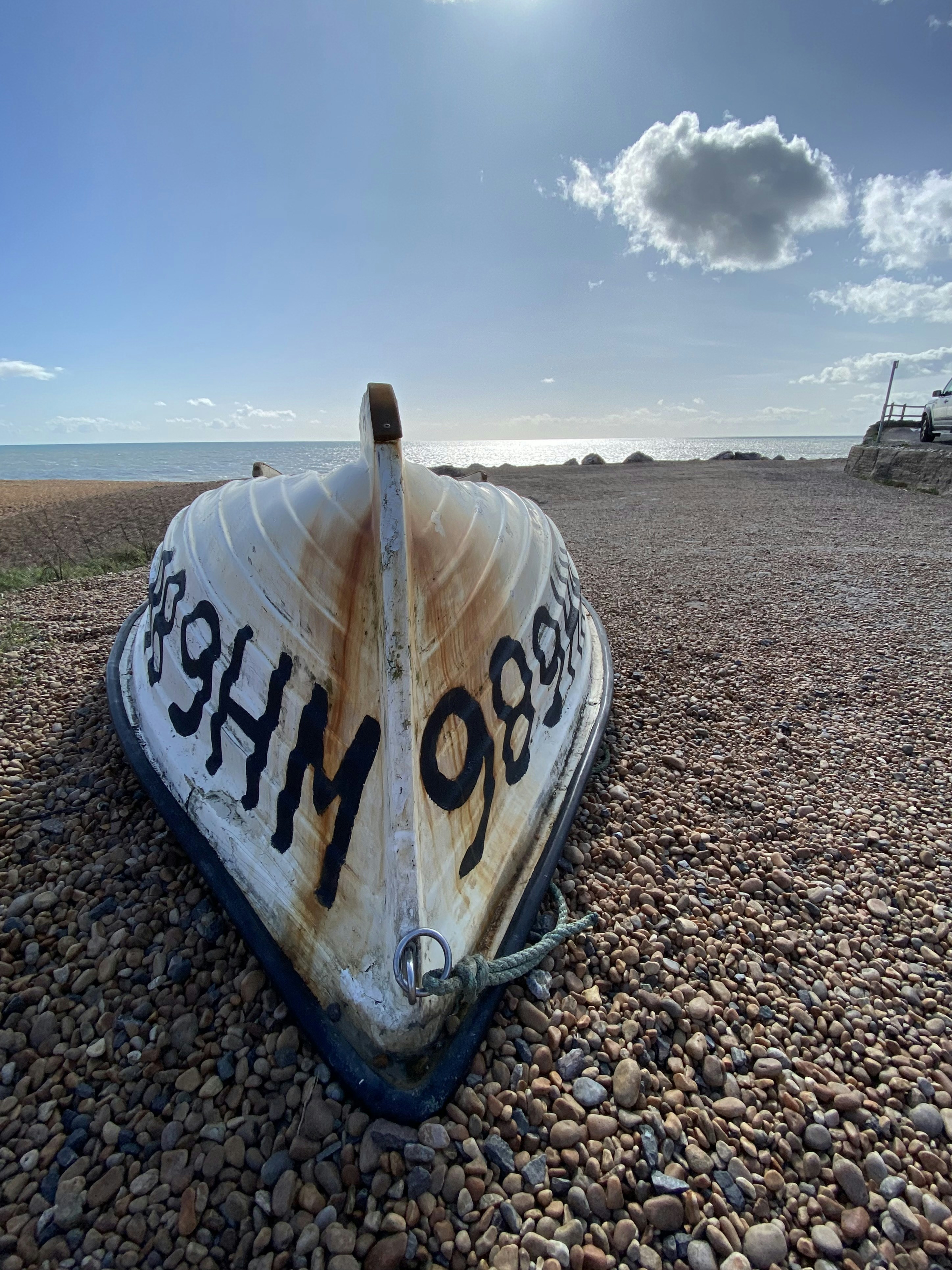 a boat sitting on top of a rocky beach