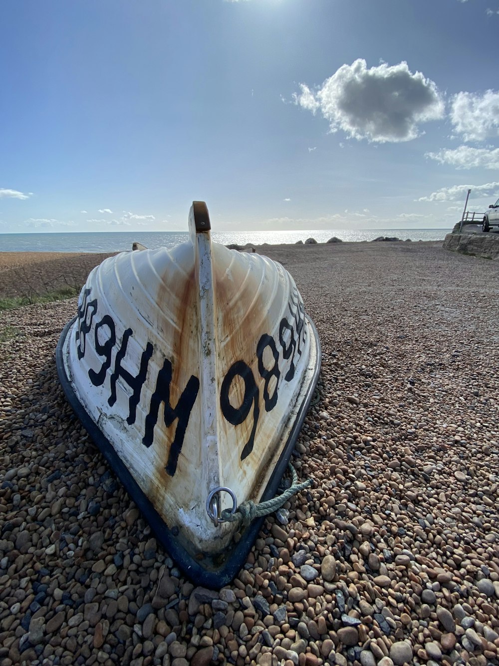 a boat sitting on top of a rocky beach