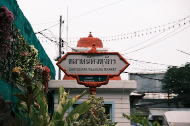 a street sign in a foreign language in front of a building