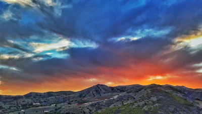 A breathtaking sunset over rolling hills with vibrant colors.