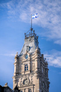 a clock tower with a flag on top of it