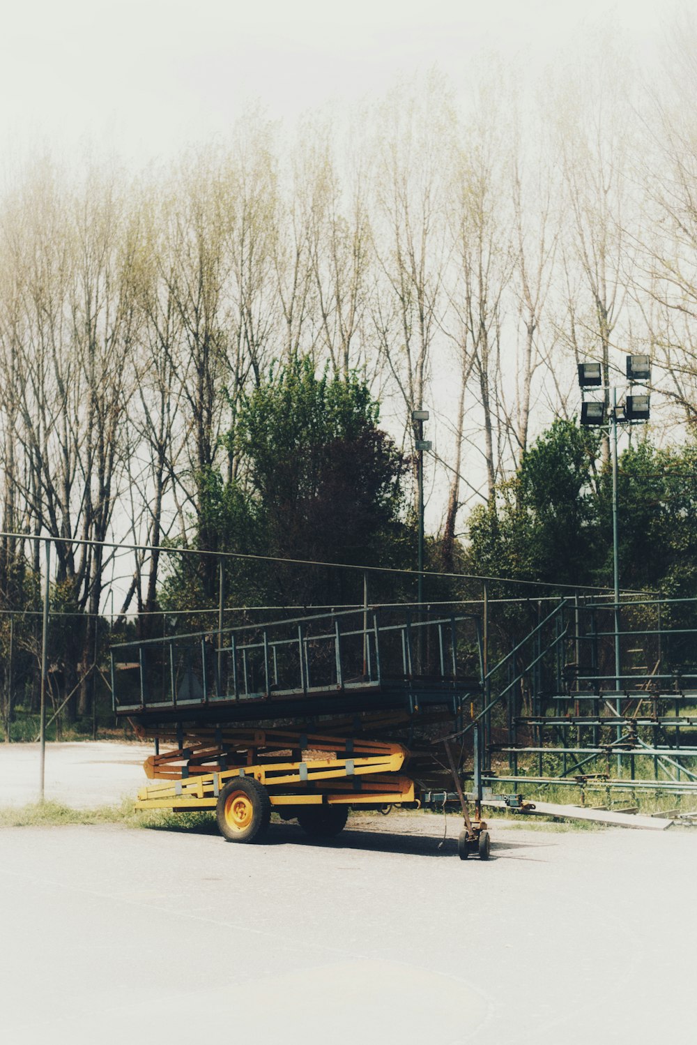 a yellow truck parked in front of a fence