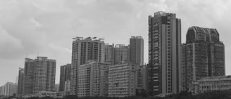 A cityscape showing a mix of residential and commercial buildings, reflecting diverse real estate projects.