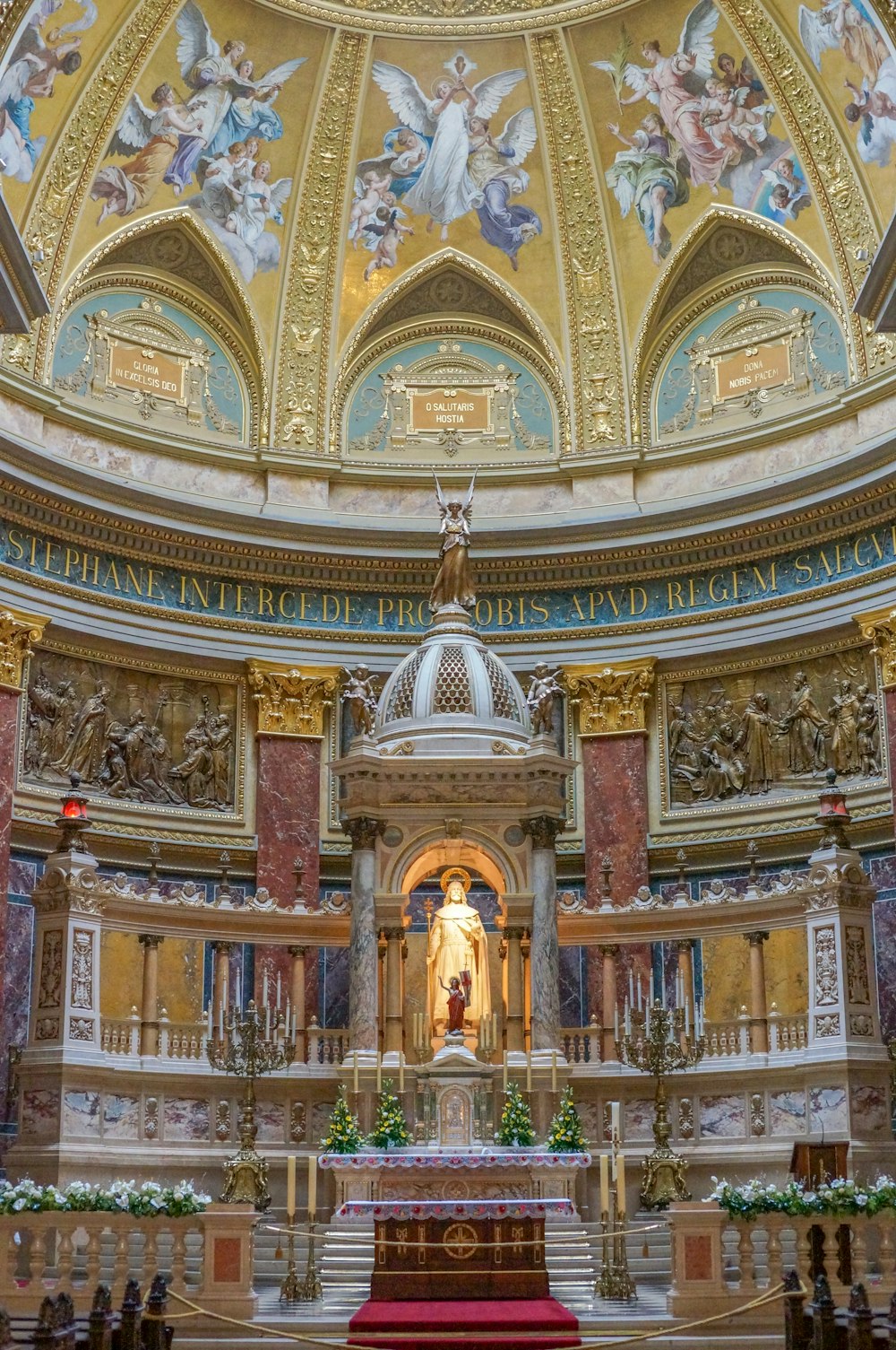 the interior of a church with a statue in the center