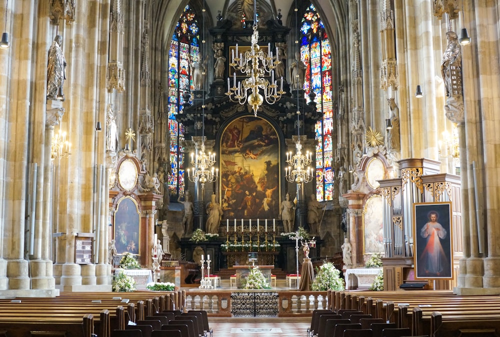 a church with a chandelier and stained glass windows