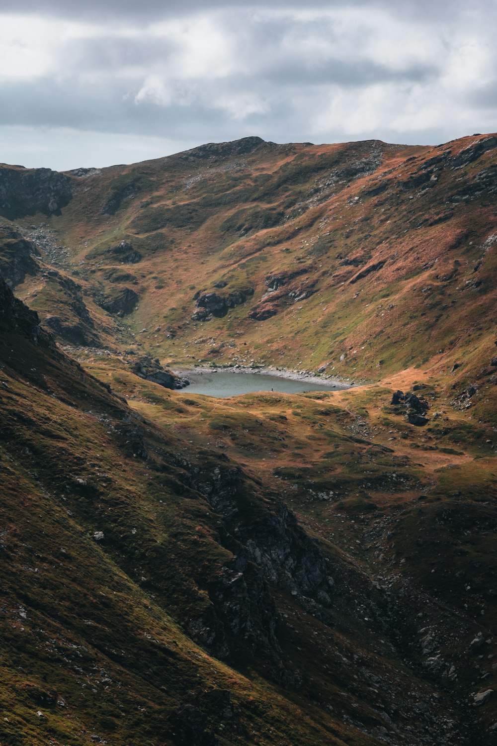 a mountain with a lake in the middle of it