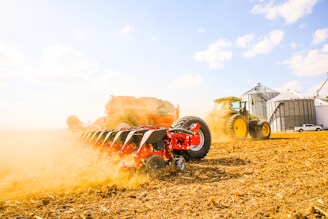 a tractor is driving through a field of hay