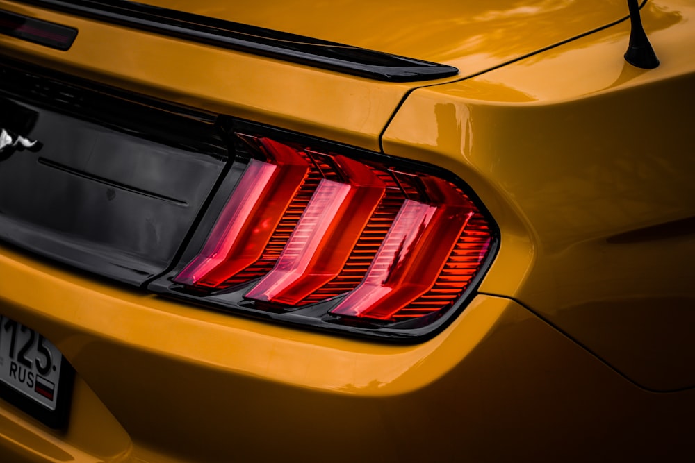 the tail lights of a yellow sports car