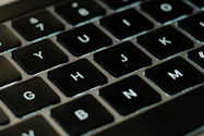 a close up of a black keyboard with white letters