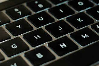 Close-up of hands typing on a laptop keyboard with highlighted correct and incorrect letters.