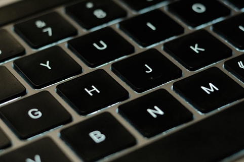 A close-up of hands typing on a laptop keyboard with EU flag icons floating above the screen.