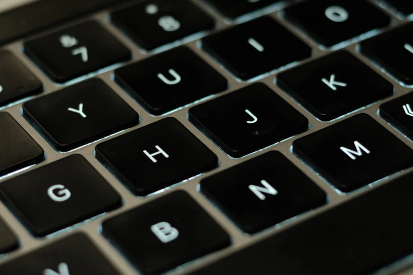 A close-up of a laptop keyboard with hands typing, symbolizing practical tech help.