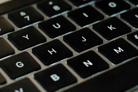 a close up of a black keyboard with white letters