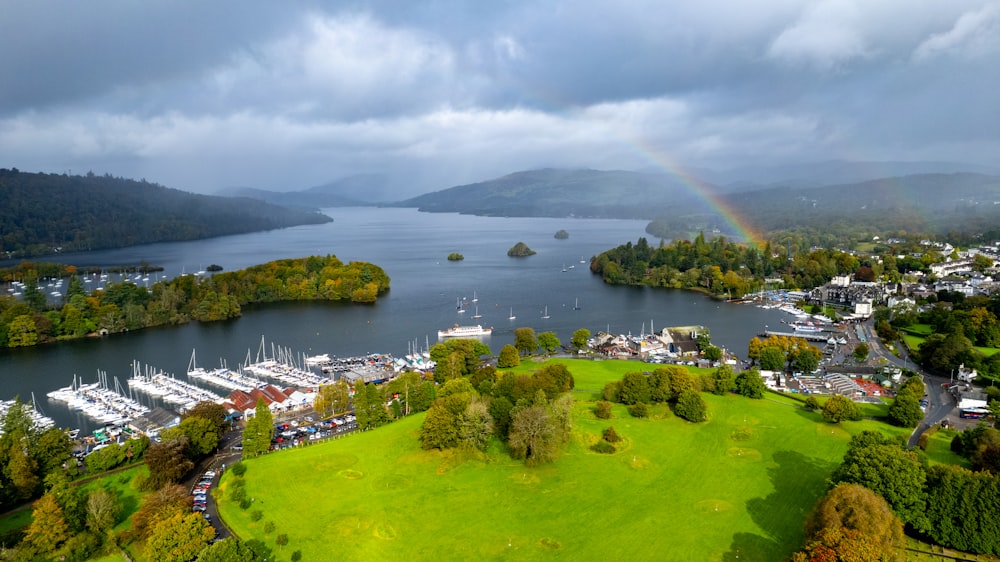an aerial view of a lake with a rainbow in the sky