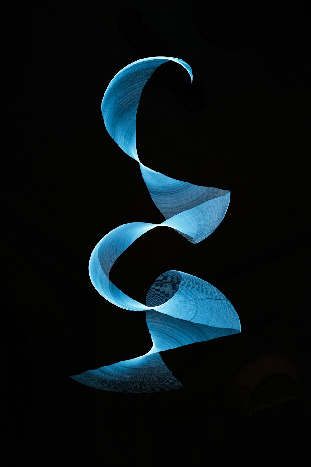 a black background with a blue swirl in the middle