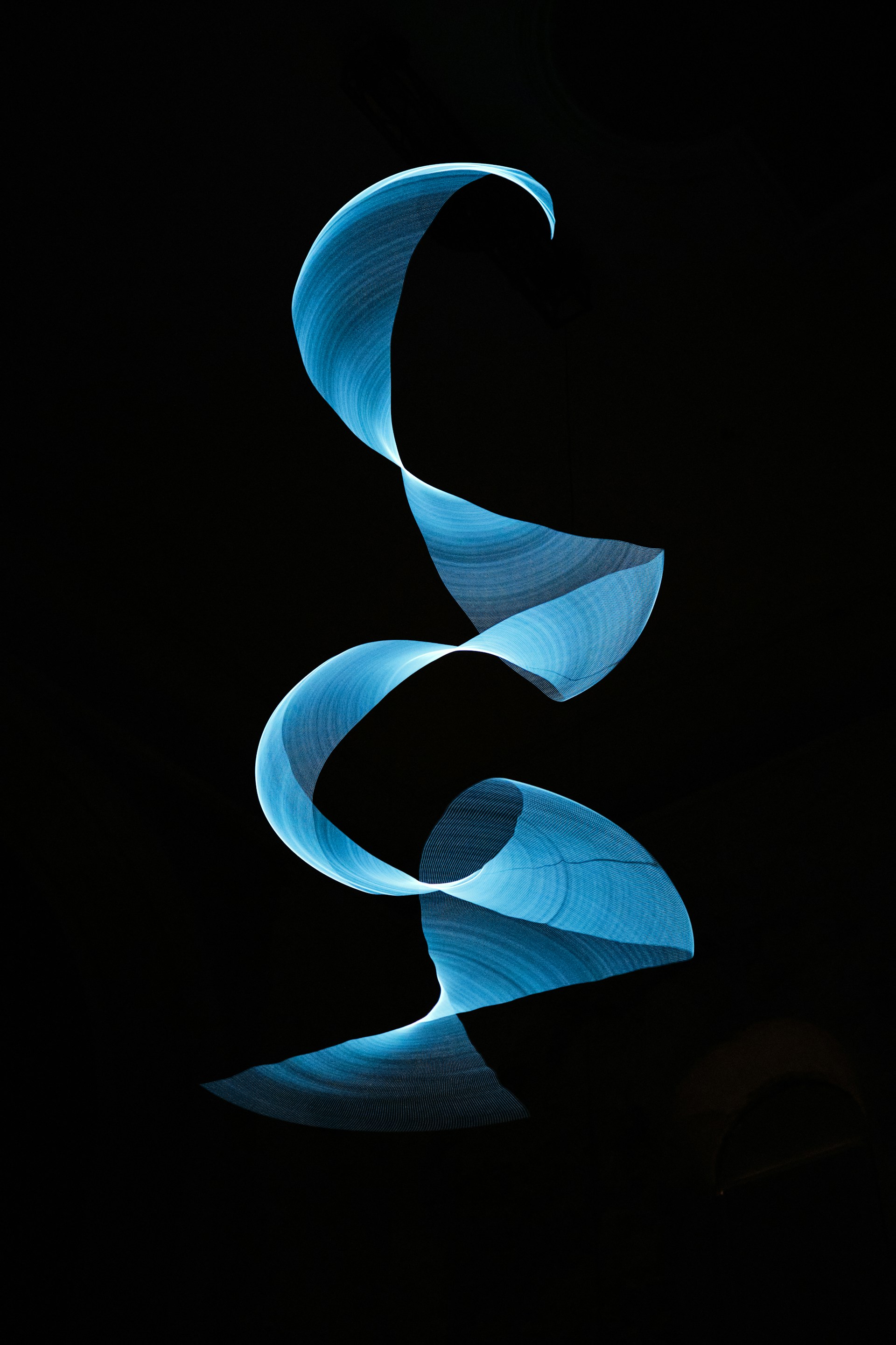 a black background with a blue swirl in the middle