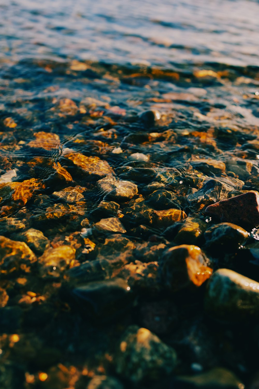 a close up of rocks and water on a beach