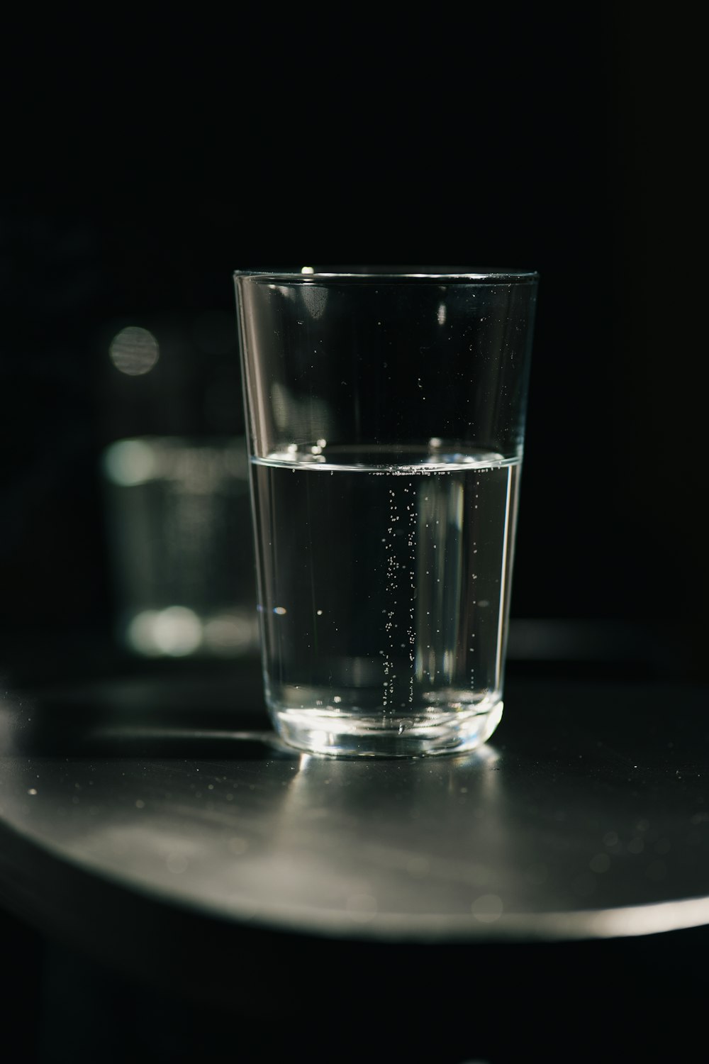 a glass of water sitting on top of a table