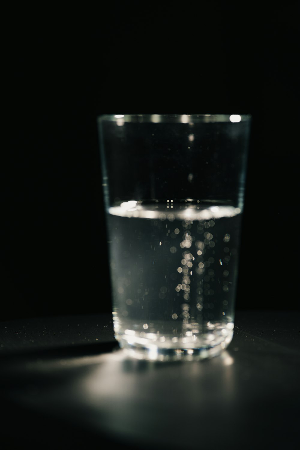 a glass of water sitting on top of a table