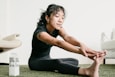 a woman sitting on the floor with her legs crossed