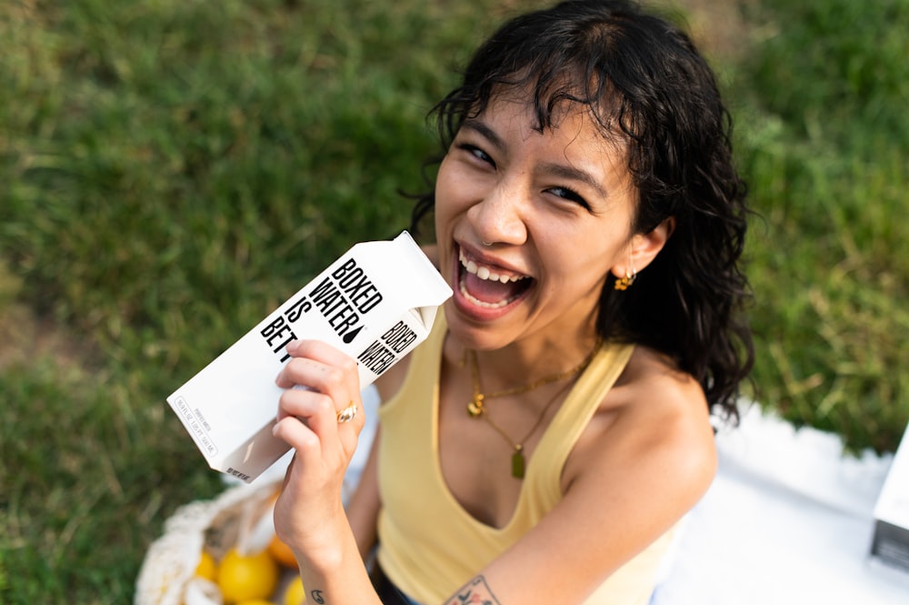 a woman holding up a piece of white paper