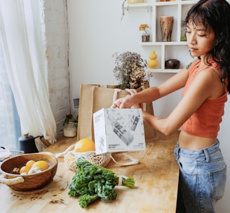 a woman standing in front of a wooden table