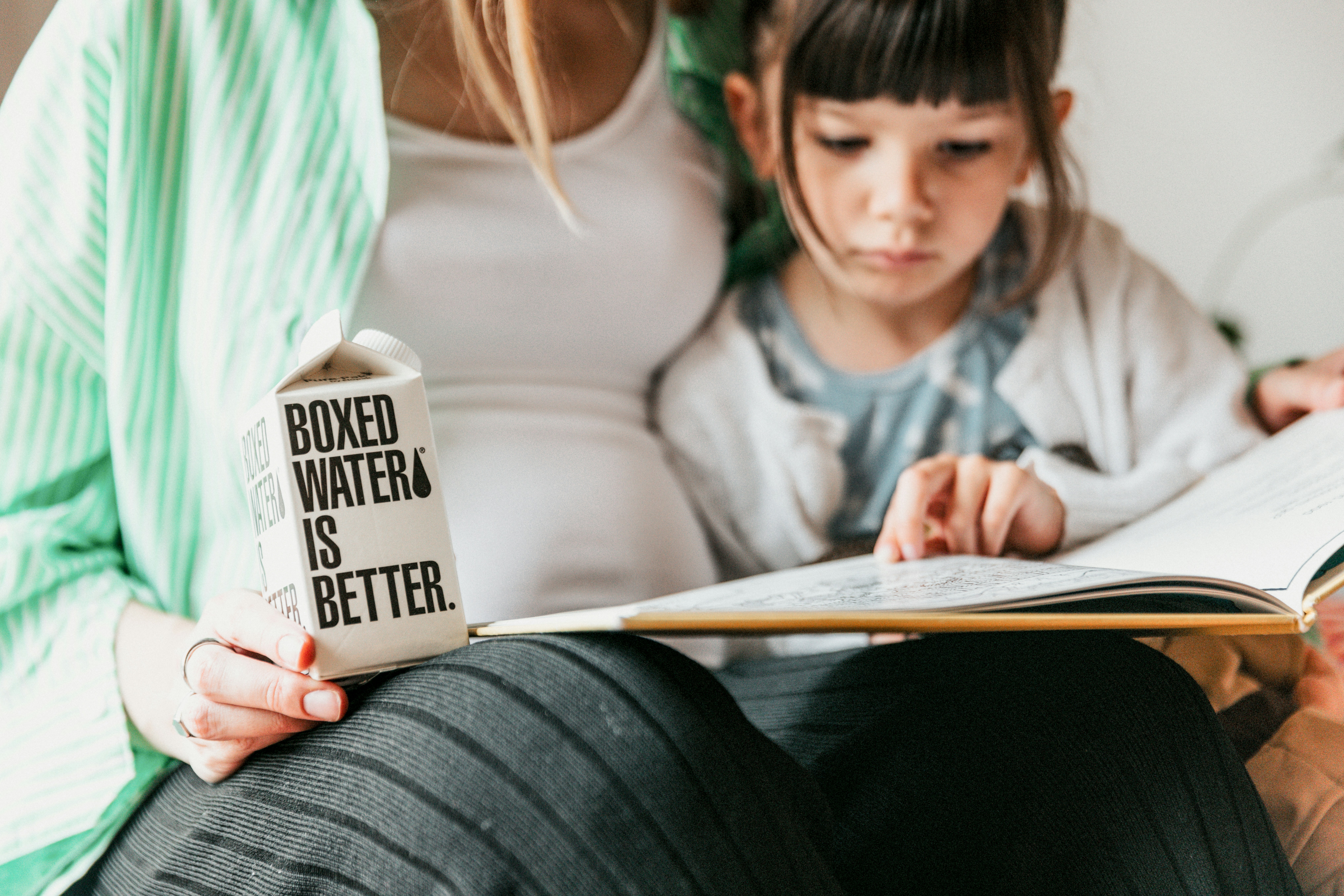 a woman and a child reading a book