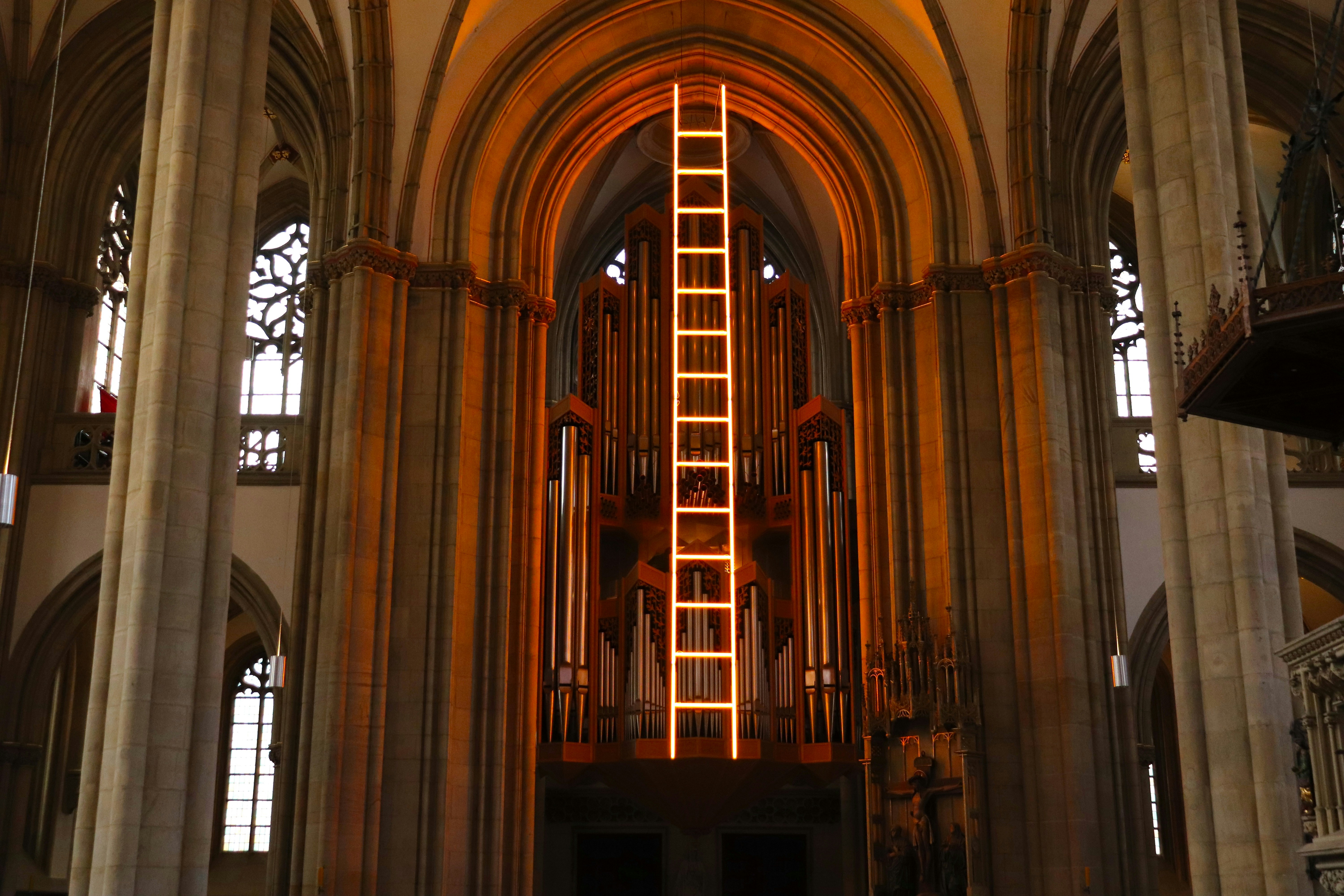 a tall building with a ladder lit up inside of it