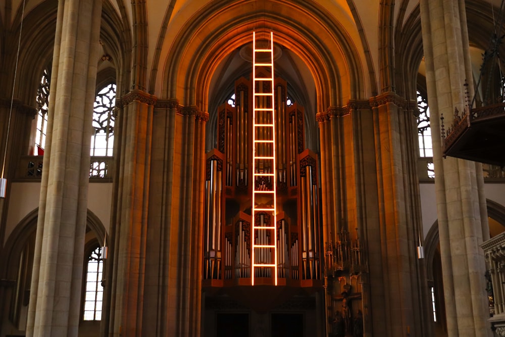 a tall building with a ladder lit up inside of it