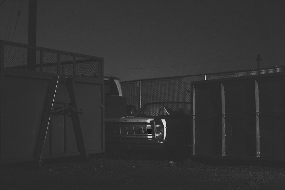 a black and white photo of a car in a trailer