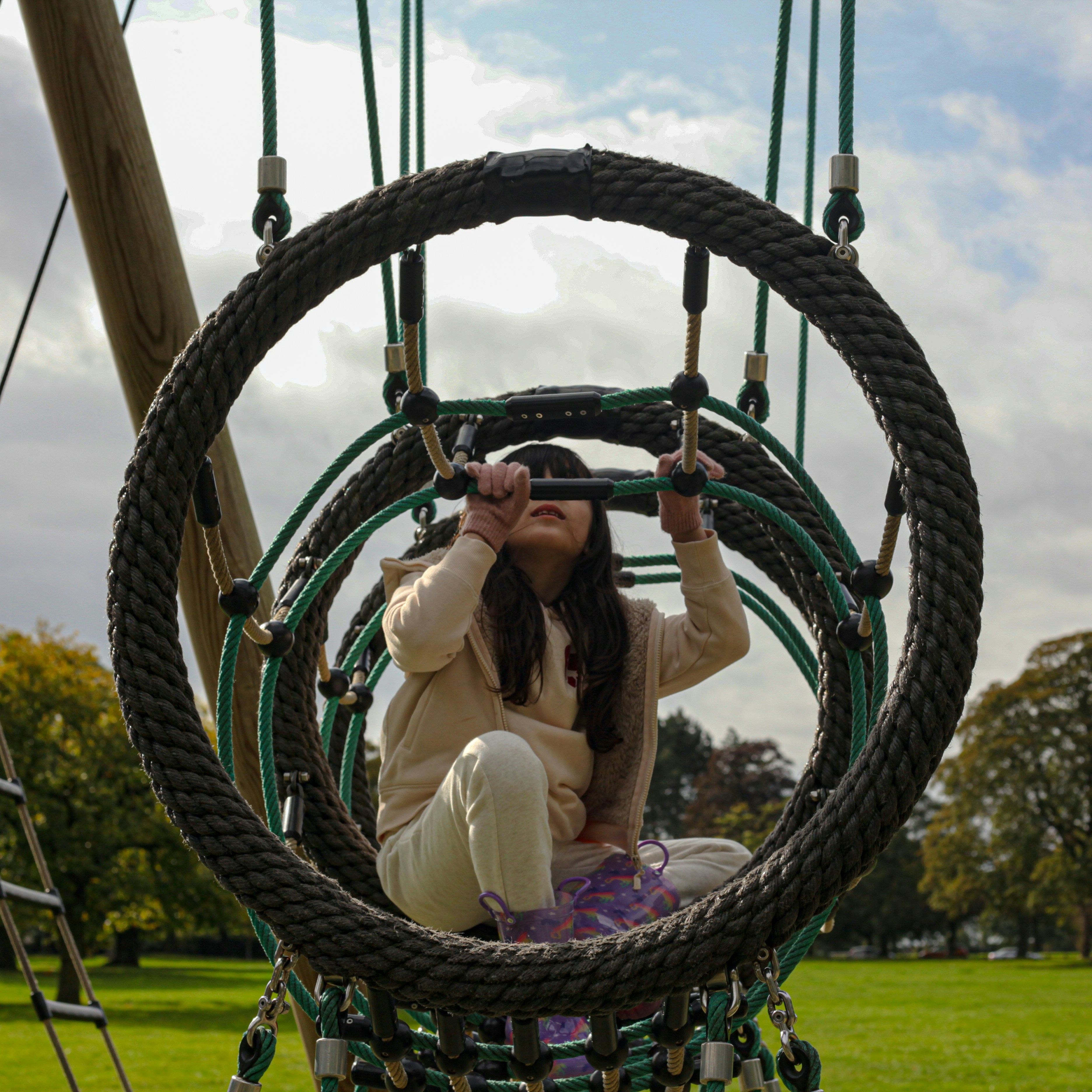 A woman sitting on top of a rope swing photo – Free Portrait Image on ...