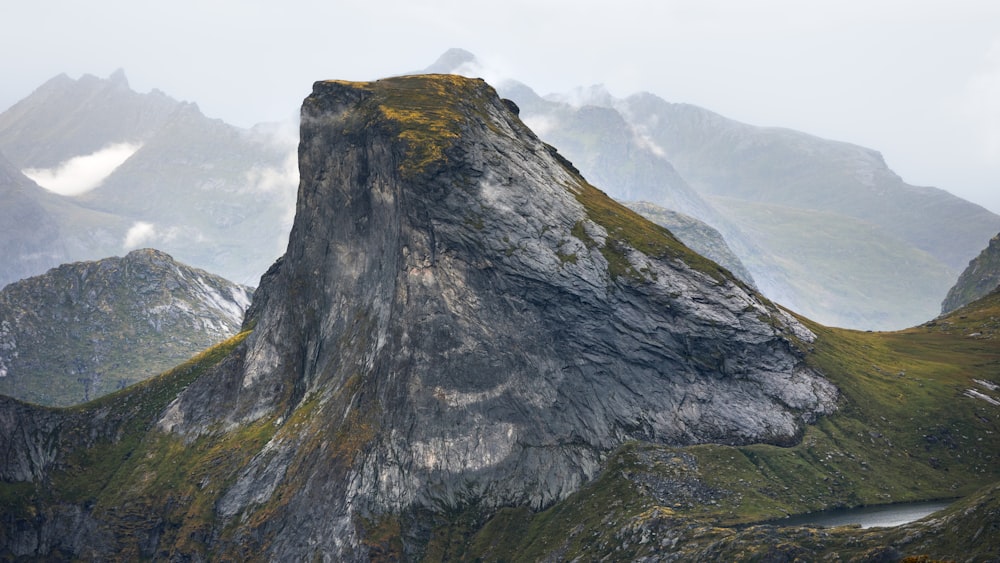 a very tall mountain with a river running through it