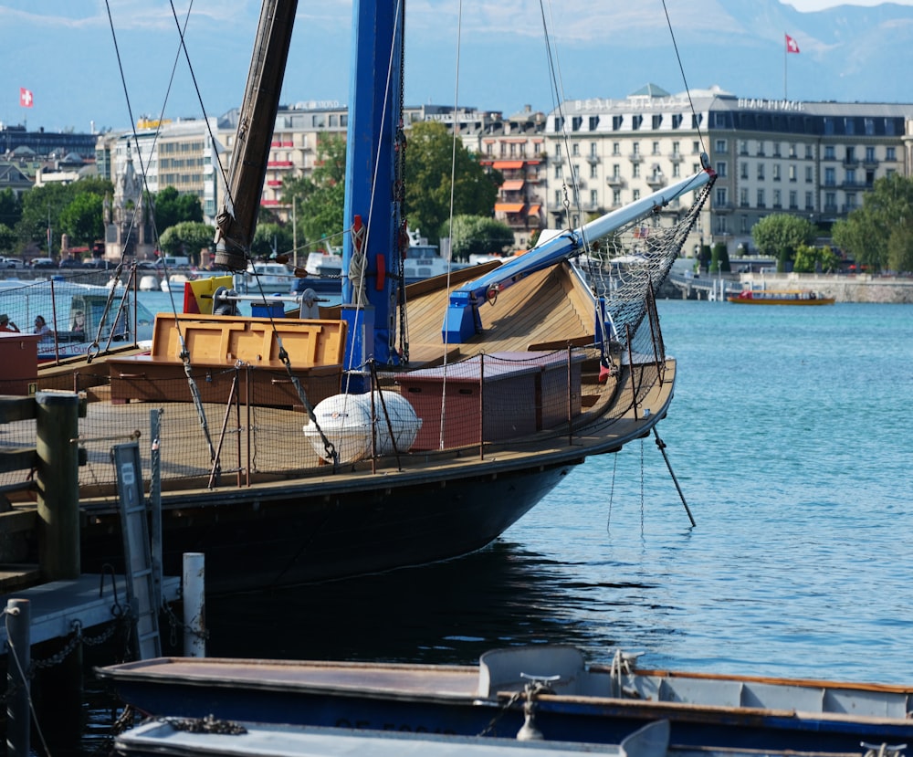 a sailboat docked at a dock in a harbor