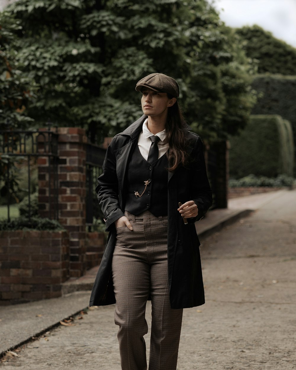 a woman in a suit and tie walking down a street