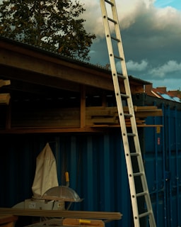 Close-up of a wooden scaffold with tools resting on it.