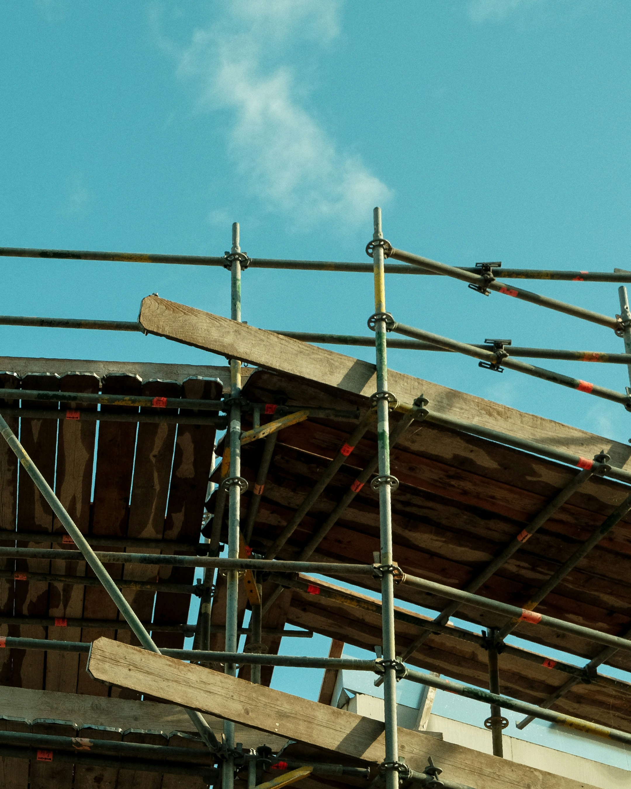 a building under construction with scaffolding and a clock
