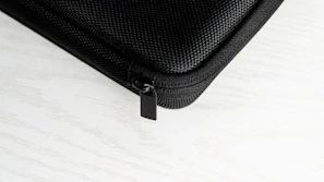 Close-up of a sleek black vxora iPhone case with soft velvet interior under soft lighting.